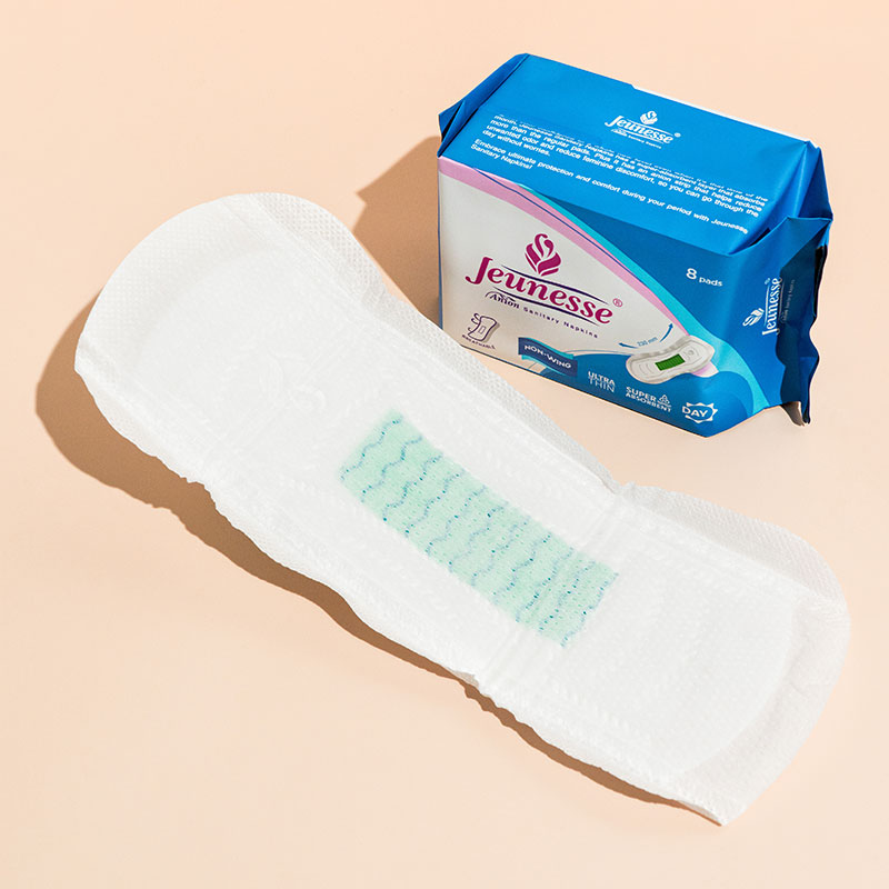 A Jeunesse pad beside its pack, showing the green anion strip down the centre